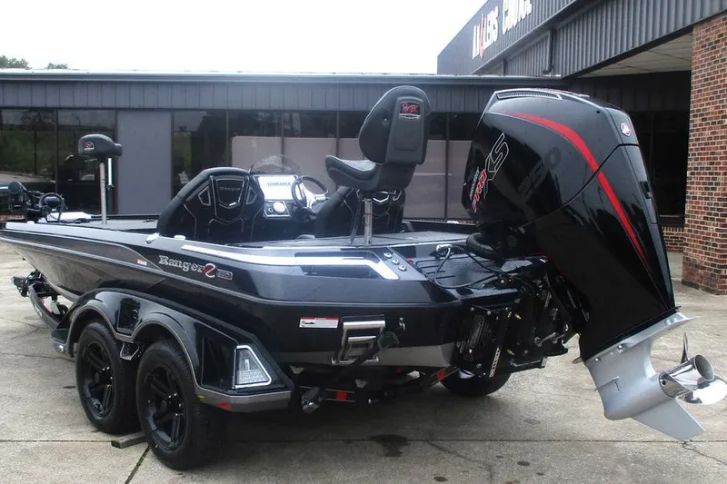 Slide: The Image of 2026 Ranger Z520R Cup-Equipped boat with powerful outboard motor, parked outside a building. - 7