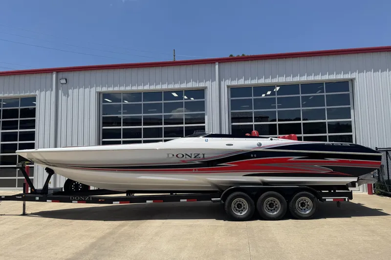 Slide: The Image of 2009 Donzi 35ZR speedboat on trailer, parked outside a garage. - 0