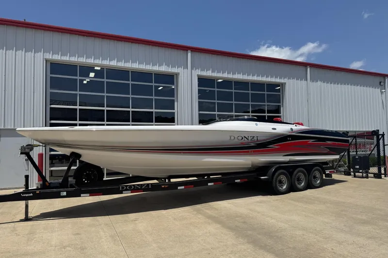 Slide: The Image of 2009 Donzi 35ZR speedboat on trailer, parked outside a large garage. - 1