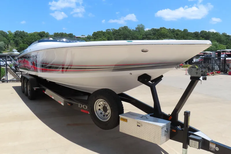 Slide: The Image of 2009 Donzi 35ZR speedboat on trailer, parked outdoors under a clear blue sky. - 10