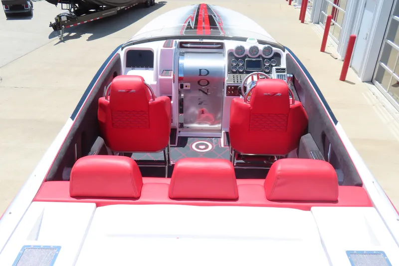 Slide: The Image of 2009 Donzi 35ZR speedboat interior with red seats and sleek dashboard design. - 14