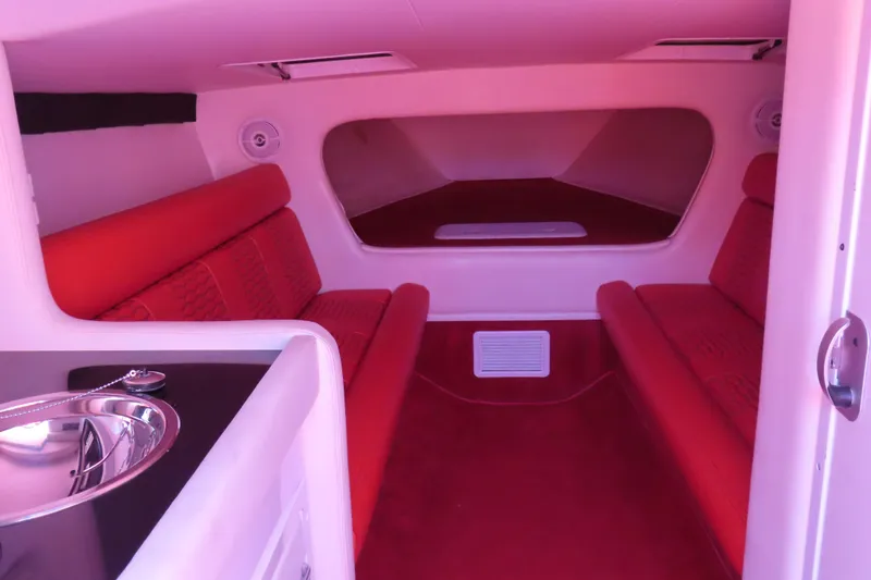 Slide: The Image of 2009 Donzi 35ZR interior with red seating and modern amenities. - 15