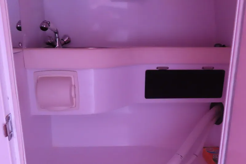 Slide: The Image of Interior of 2009 Donzi 35ZR boat showing compact bathroom sink and fixtures. - 18