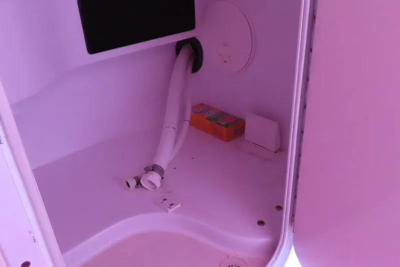 Slide: The Image of 2009 Donzi 35ZR interior compartment with hose and storage items. - 20