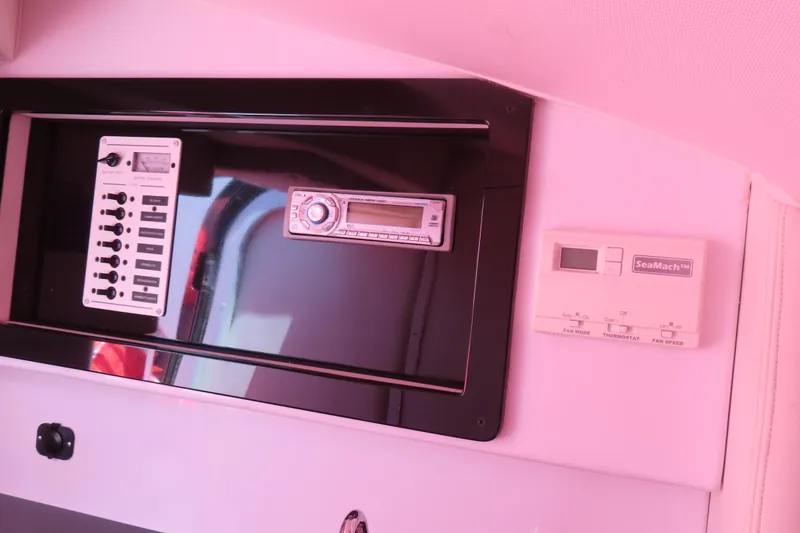 Slide: The Image of Control panel and stereo system inside a 2009 Donzi 35ZR boat cabin. - 21