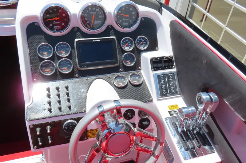 Slide: The Image of Dashboard of a 2009 Donzi 35ZR boat with gauges and controls. - 22