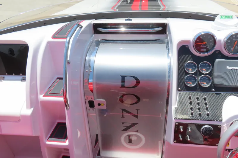 Slide: The Image of 2009 Donzi 35ZR boat dashboard with gauges and controls, featuring sleek design elements. - 23