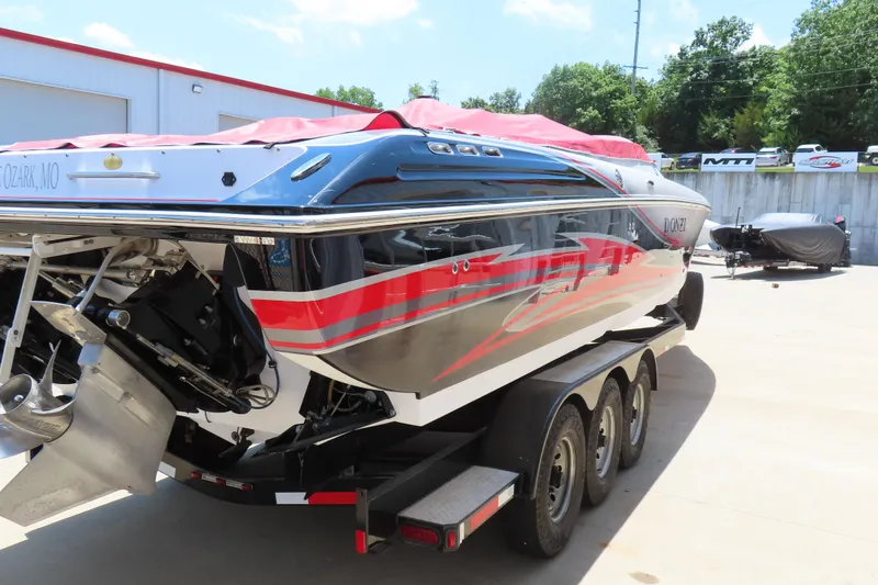 Slide: The Image of 2009 Donzi 35ZR speedboat on trailer, featuring sleek design and vibrant red accents. - 26
