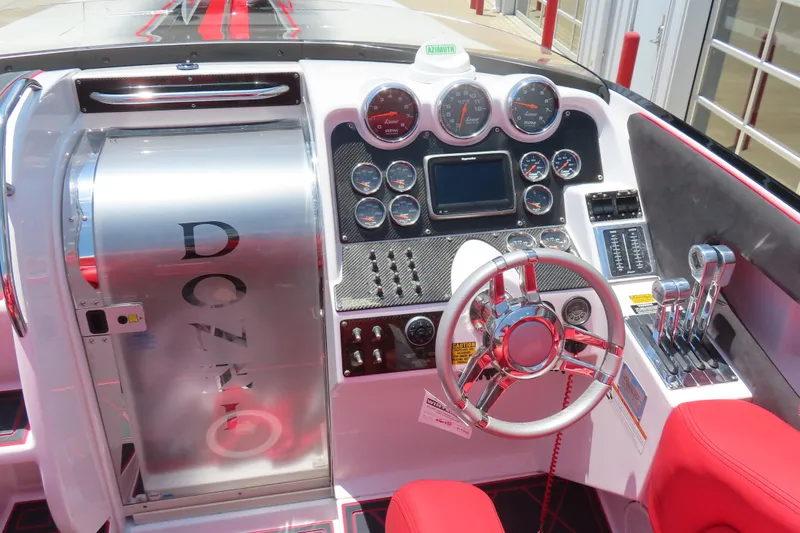 Slide: The Image of 2009 Donzi 35ZR boat dashboard with gauges, steering wheel, and controls. - 6