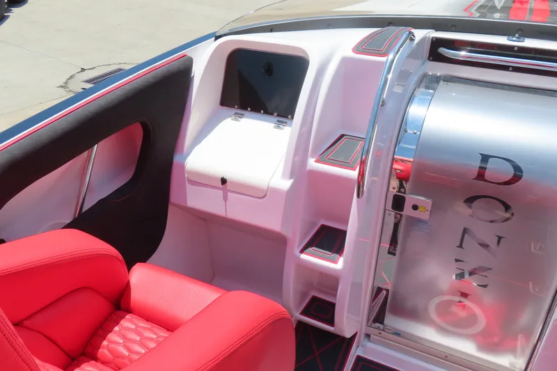 Slide: The Image of 2009 Donzi 35ZR boat interior with red seating and sleek design elements. - 7