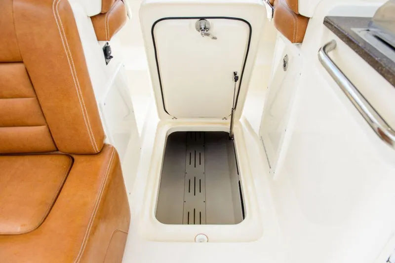 Slide: The Image of Manufacturer Provided Image: 2023 Scout 255 Dorado boat interior storage compartment with brown leather seats. - 14
