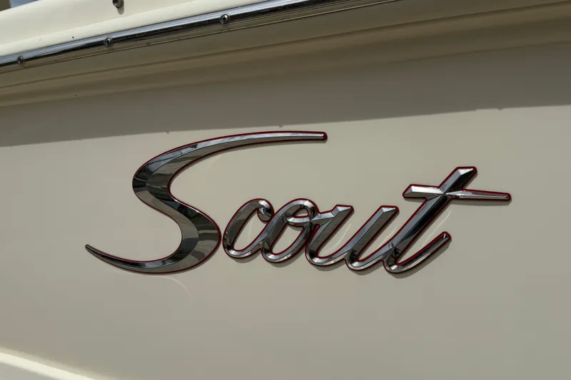 Slide: The Image of Scout 255 Dorado 2023 logo on boat exterior, chrome lettering on white surface. - 20
