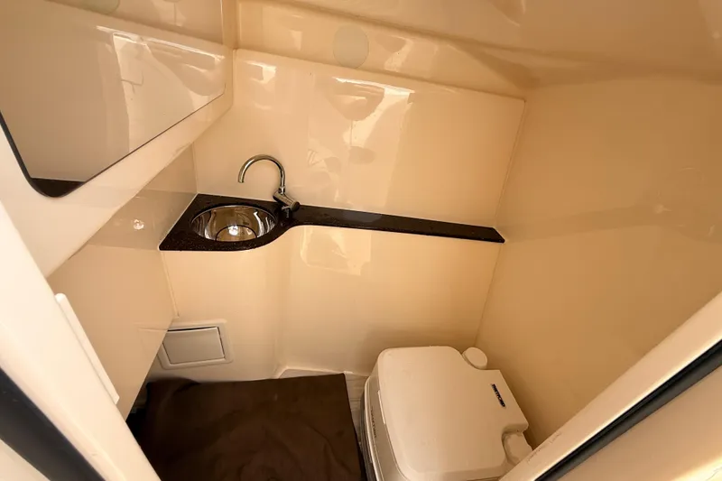 Slide: The Image of 2023 Scout 255 Dorado boat interior with sink and portable toilet. - 22