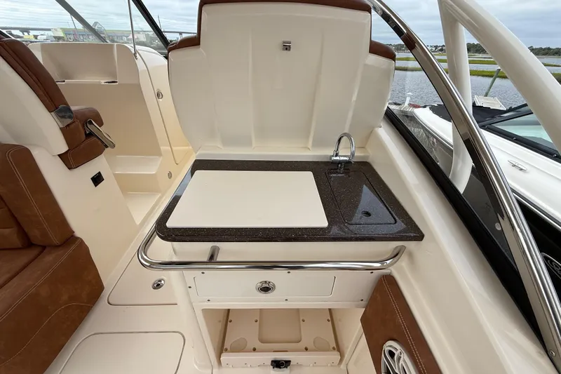 Slide: The Image of 2023 Scout 255 Dorado boat interior with sink and seating area. - 26