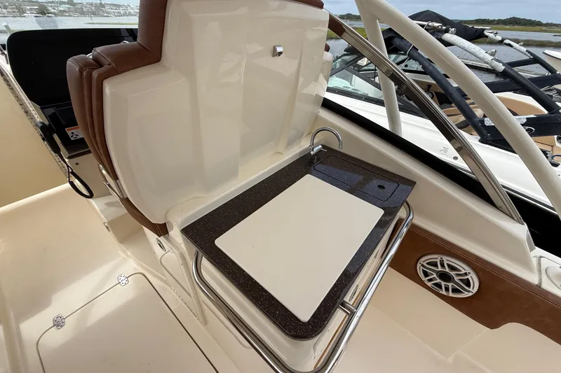 Slide: The Image of 2023 Scout 255 Dorado boat interior with sink and cutting board. - 29