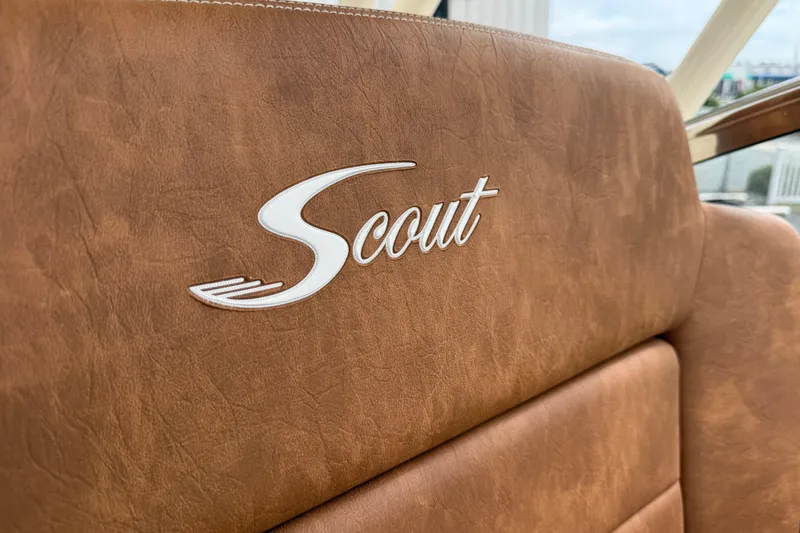 Slide: The Image of Luxurious brown leather seat with Scout logo on 2023 Scout 255 Dorado boat. - 34