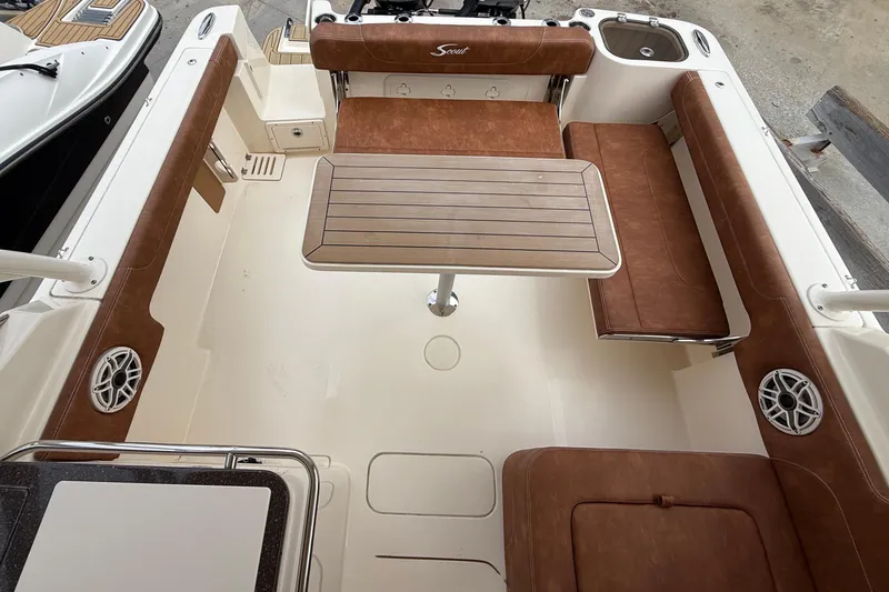 Slide: The Image of 2023 Scout 255 Dorado boat interior with brown seating and central table. - 5
