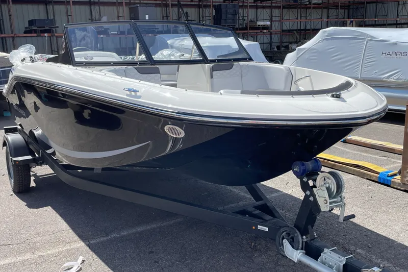 The Image of 2026 Bayliner Element E17 boat on trailer in outdoor storage area. - 0