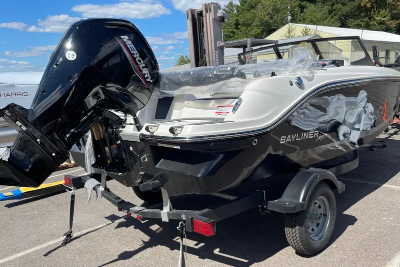 Slide: The Image of 2026 Bayliner Element E17 boat with Mercury engine on trailer, parked outdoors. - 4