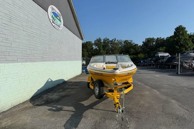 Slide: The Image of Yellow 2013 Tahoe Q5 boat on trailer outside Water Werks Marine building. - 2