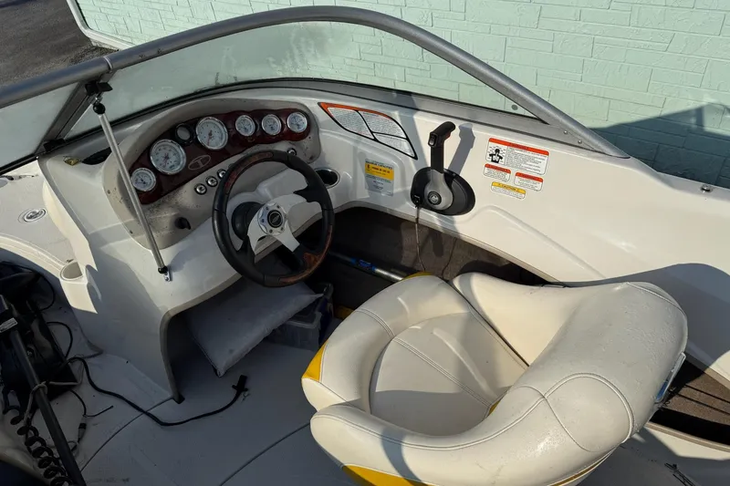 Slide: The Image of 2013 Tahoe Q5 boat cockpit with steering wheel, gauges, and cushioned seat. - 5