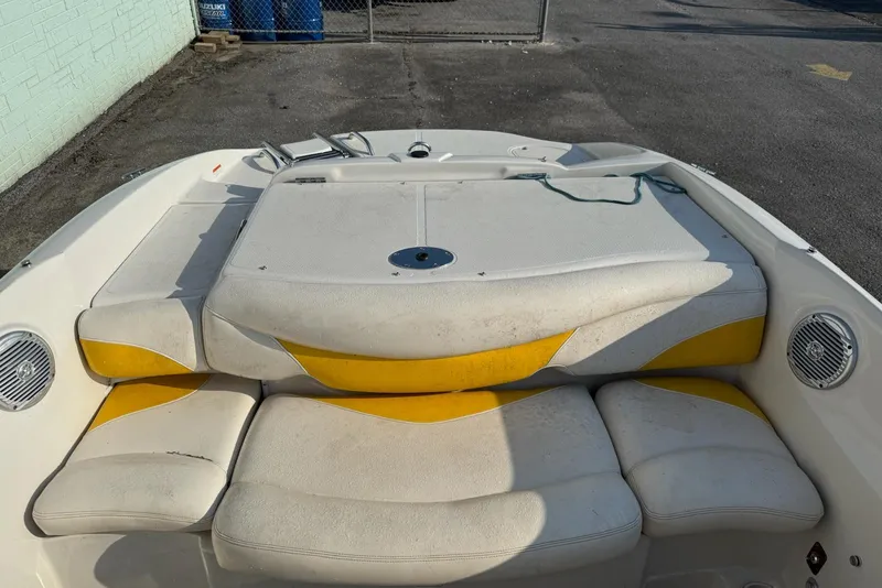 Slide: The Image of 2013 Tahoe Q5 boat interior with yellow and white seating, outdoor setting. - 6