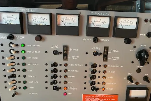 Slide: The Image of Control panel of a 1989 Sea Ray 390 Express Cruiser with voltage and system indicators. - 10
