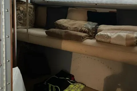 Slide: The Image of Interior cabin of 1989 Sea Ray 390 Express Cruiser with cushions and pillows. - 11