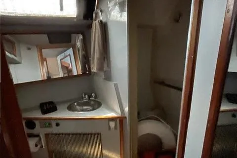 Slide: The Image of 1989 Sea Ray 390 Express Cruiser bathroom interior with sink and mirror. - 4