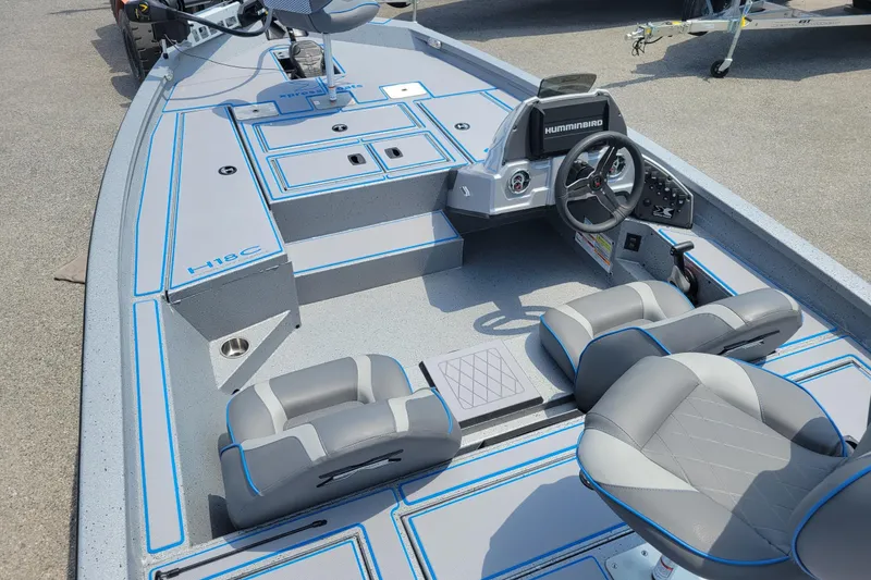 The Image of 2026 Xpress H18 Bass boat interior with steering console and seating. - 1