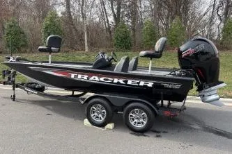 Slide: The Image of 2026 Tracker Pro Team 195 boat on trailer, parked outdoors. - 5