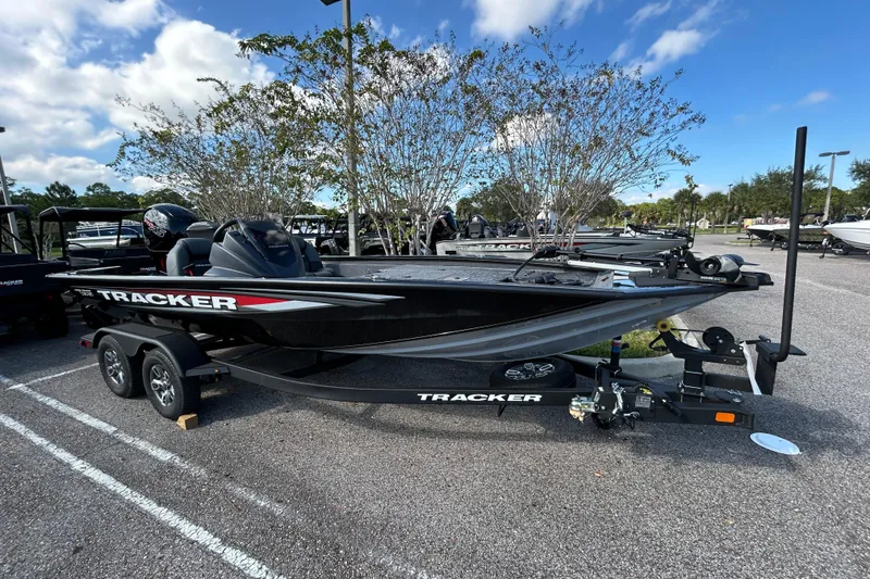 The Image of 2026 Tracker Pro Team 195 boat on trailer in parking lot, under blue sky. - 0