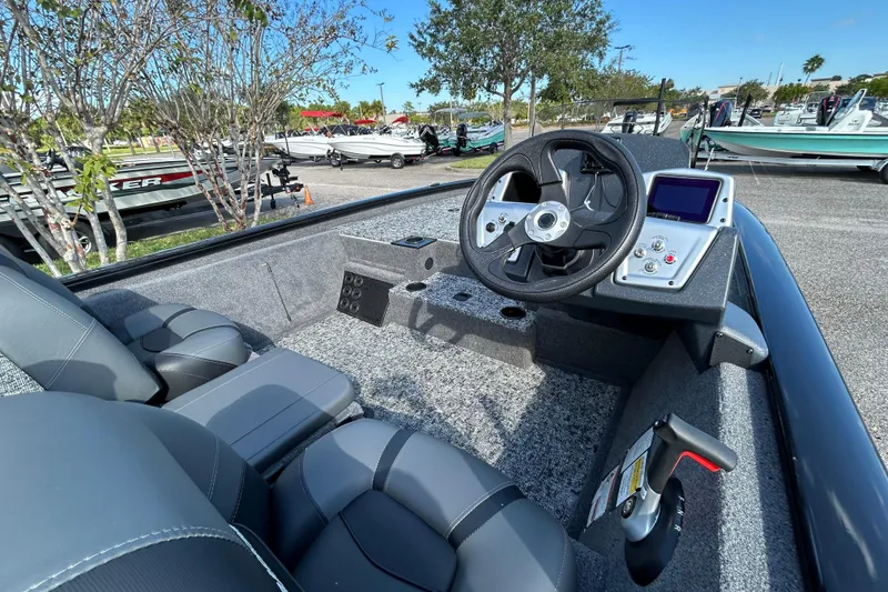 Slide: The Image of 2026 Tracker Pro Team 195 boat interior with steering wheel and control panel. - 4