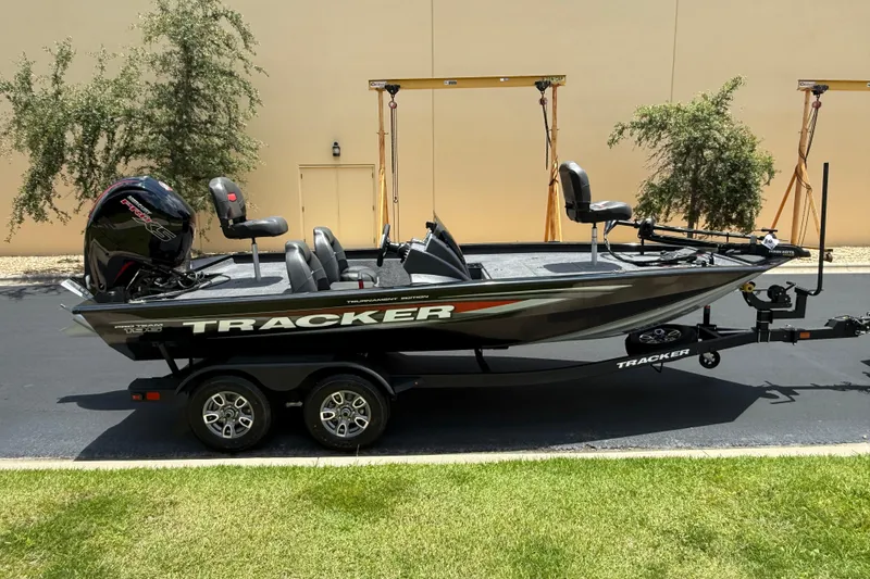 Slide: The Image of 2026 Tracker Pro Team 195 boat on trailer, parked outdoors. - 3
