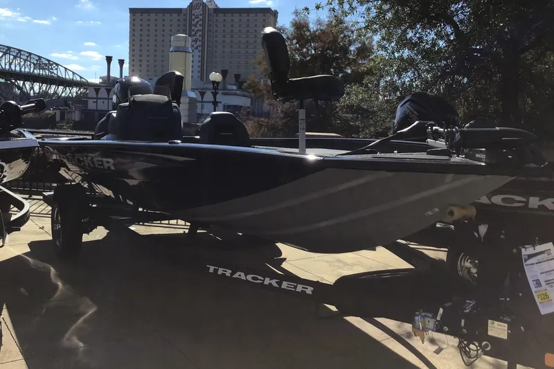 The Image of 2026 Tracker Pro Team 195 boat displayed outdoors with cityscape background. - 0