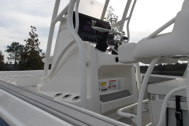 Slide: The Image of 2026 Mako 24 APEX boat console with white seating and control panel. - 11