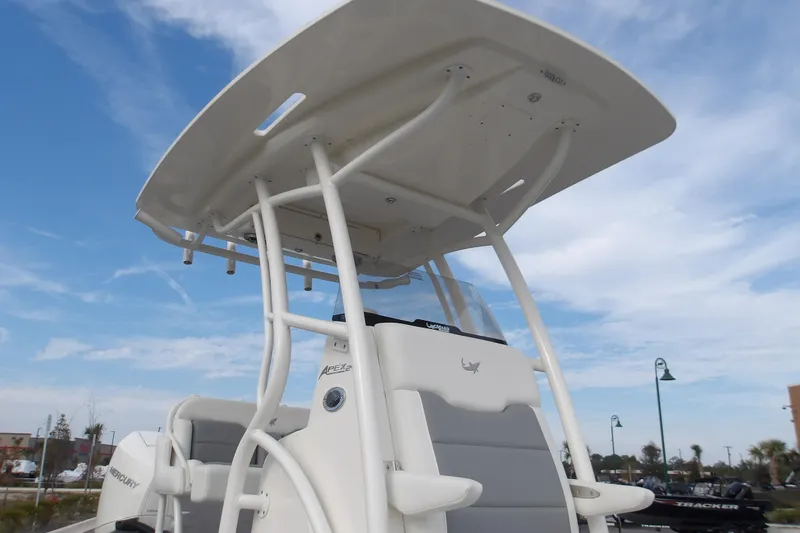 Slide: The Image of 2026 Mako 24 APEX boat with T-top against a clear blue sky. - 13