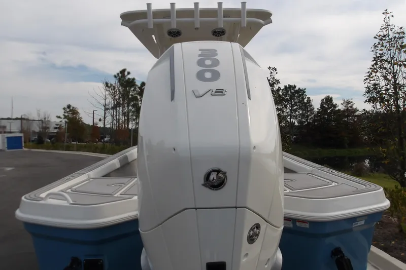 Slide: The Image of 2026 Mako 24 APEX boat with powerful 300 V8 engine, parked outdoors. - 2