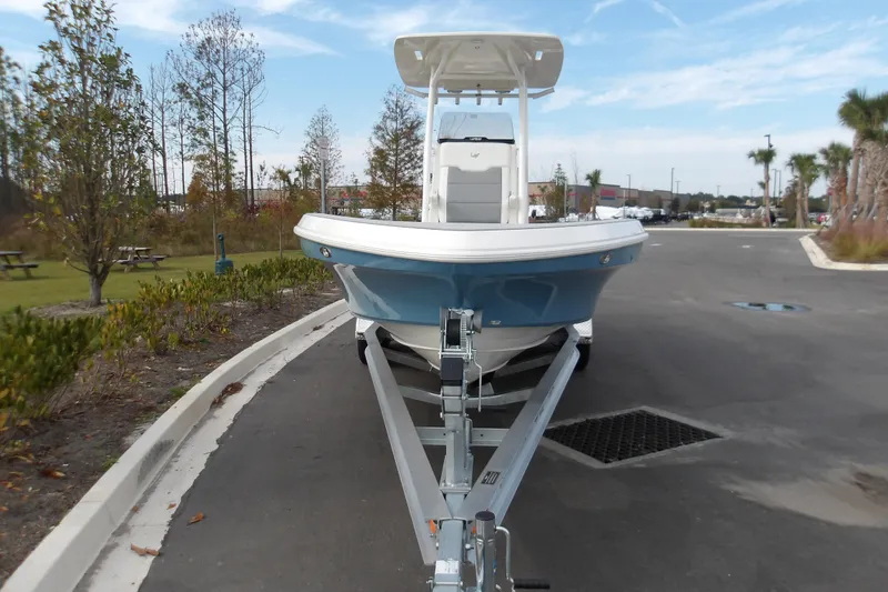 Slide: The Image of 2026 Mako 24 APEX boat on trailer, parked in outdoor setting. - 5