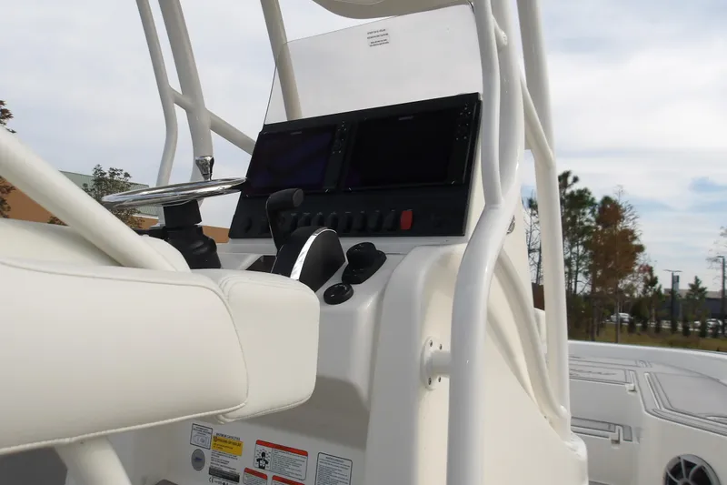 Slide: The Image of 2026 Mako 24 APEX boat console with steering wheel and control panel. - 7
