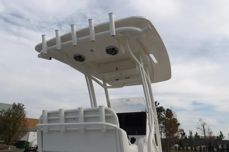 Slide: The Image of 2026 Mako 24 APEX boat with T-top and rod holders under cloudy sky. - 8