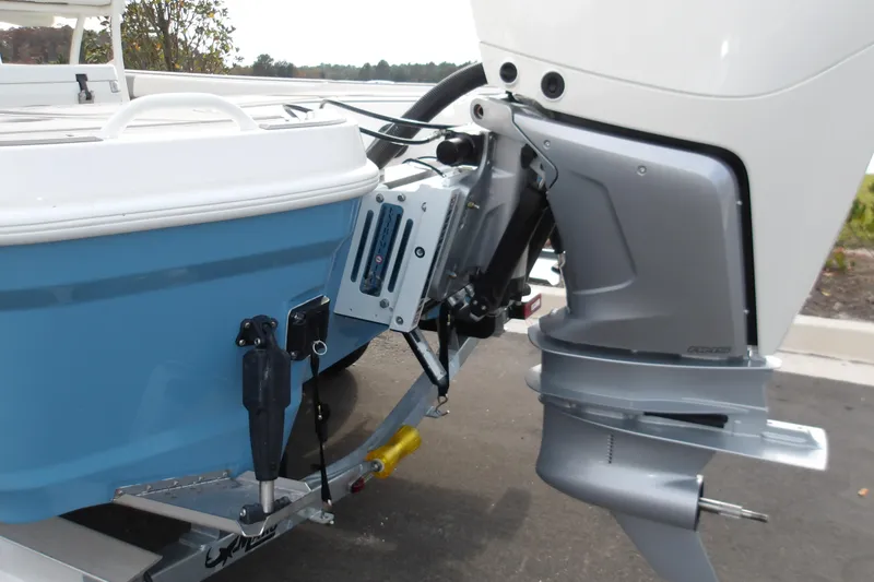 Slide: The Image of 2026 Mako 24 APEX boat with outboard motor, blue hull, and trailer. - 9