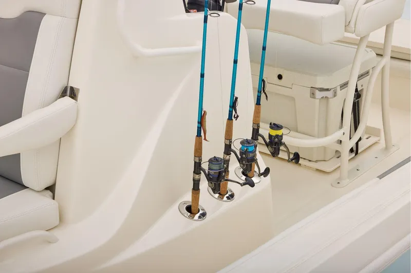 Slide: The Image of Open storage compartment on 2026 Mako 24 APEX boat with safety gear and equipment. - 22