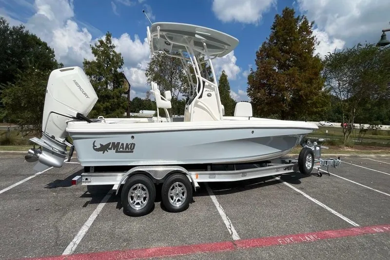 Slide: The Image of 2026 Mako 24 APEX boat on trailer in parking lot, under clear sky. - 5