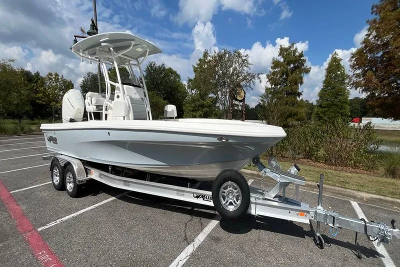 Slide: The Image of 2026 Mako 24 APEX boat on trailer in parking lot. - 6