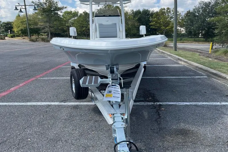 Slide: The Image of 2026 Mako 24 APEX boat on trailer in parking lot, sunny day. - 7