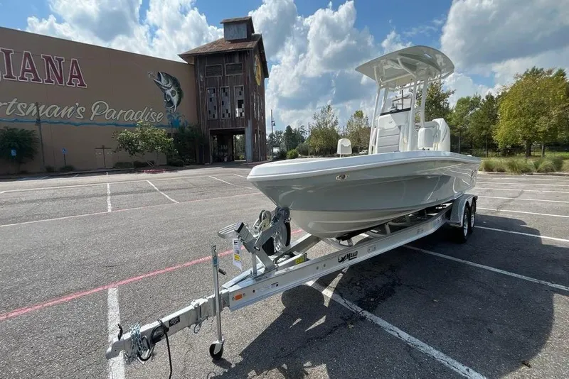 Slide: The Image of 2026 Mako 24 APEX boat on trailer, featuring sleek design and modern amenities. - 8