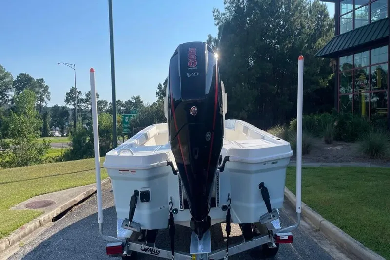 Slide: The Image of 2026 Mako 24 APEX boat on trailer outside Outdoor World store. - 3