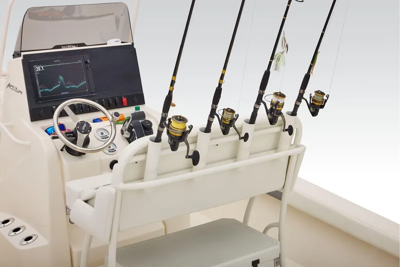 Slide: The Image of 2026 Mako 24 APEX boat interior with cushioned seating and steering wheel. - 42