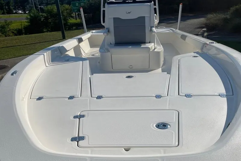 Slide: The Image of 2026 Mako 24 APEX boat on trailer, parked outdoors in sunny setting. - 5